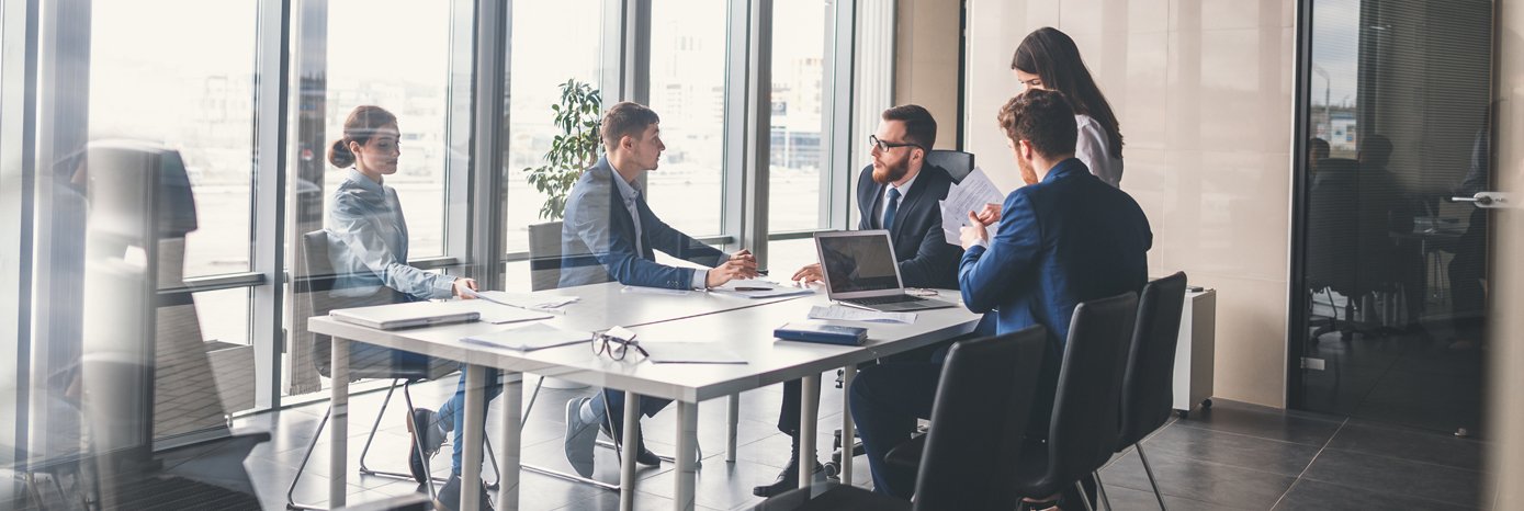 Stock image of 5 suits at a table